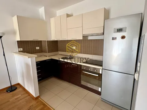Small kitchen with upper and lower cabinets and built-in appliances. - image 3