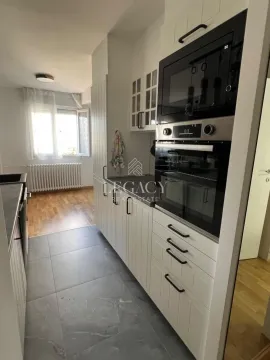 White kitchen with built-in oven and microwave. - image 6