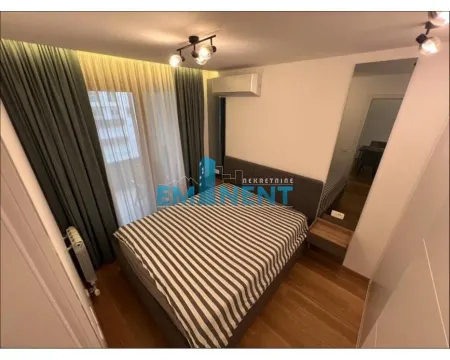 Furnished bedroom with a double bed, air conditioning, and curtains. - image 4
