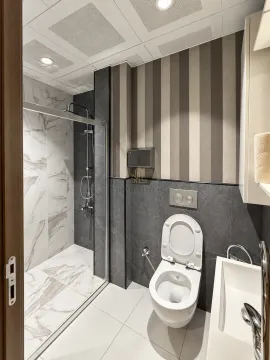 A modern bathroom equipped with a walk-in shower and sanitary ware. - image 20