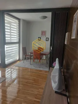 Living room with dining area and wooden flooring. - image 3