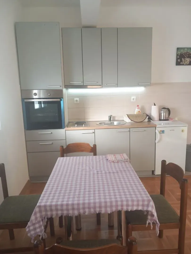 Kitchen with a dining table and grey cabinets.