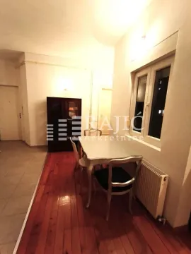 Dining area with a table, chairs, and wooden flooring. - image 6