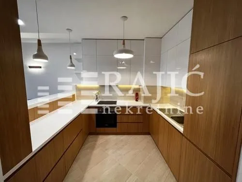 Modern kitchen with wooden elements and built-in appliances.