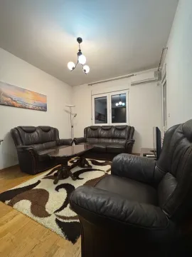 Living room with a seating set and a wooden coffee table. - image 4