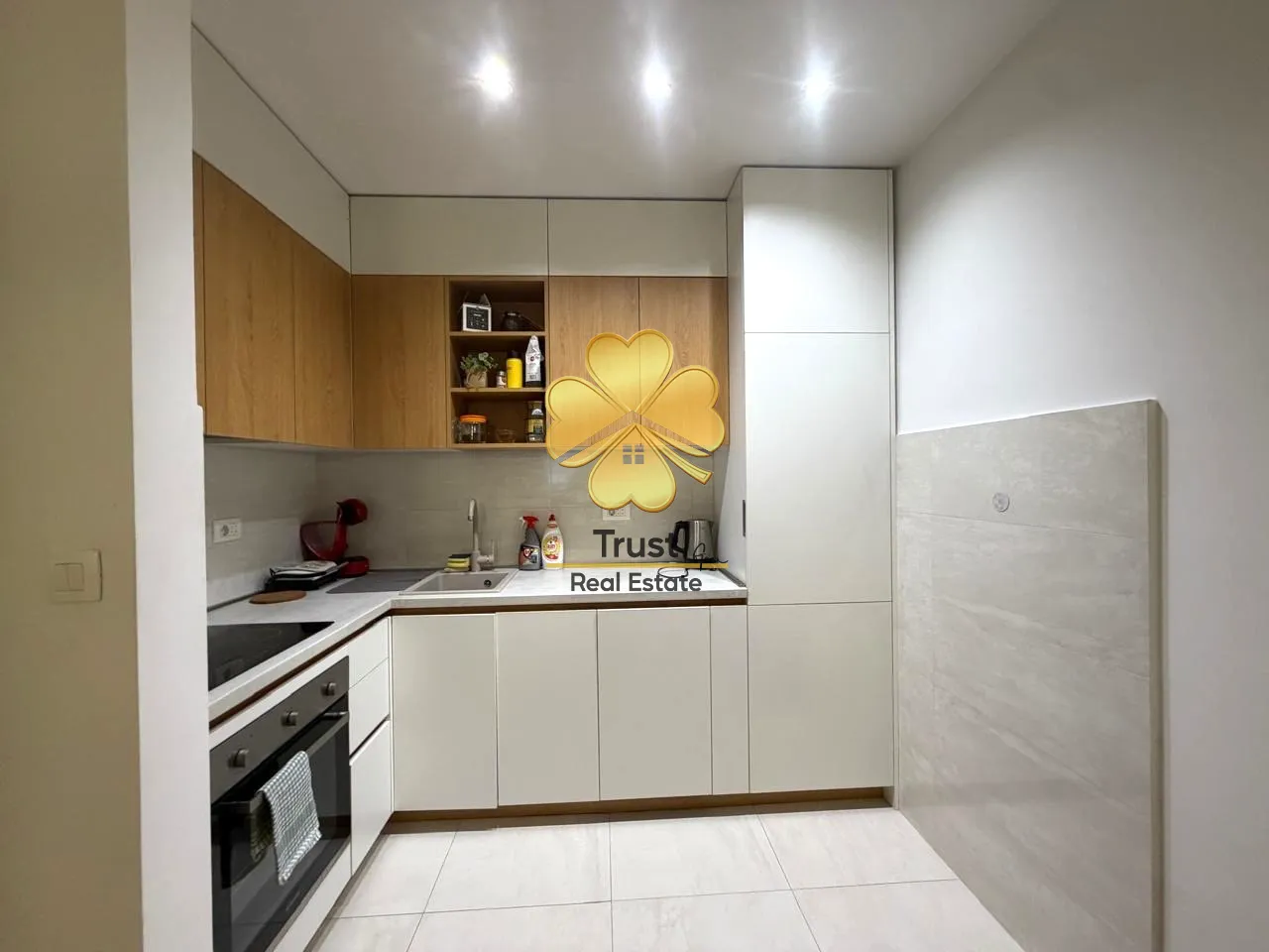 Modern kitchen with white and wooden elements.