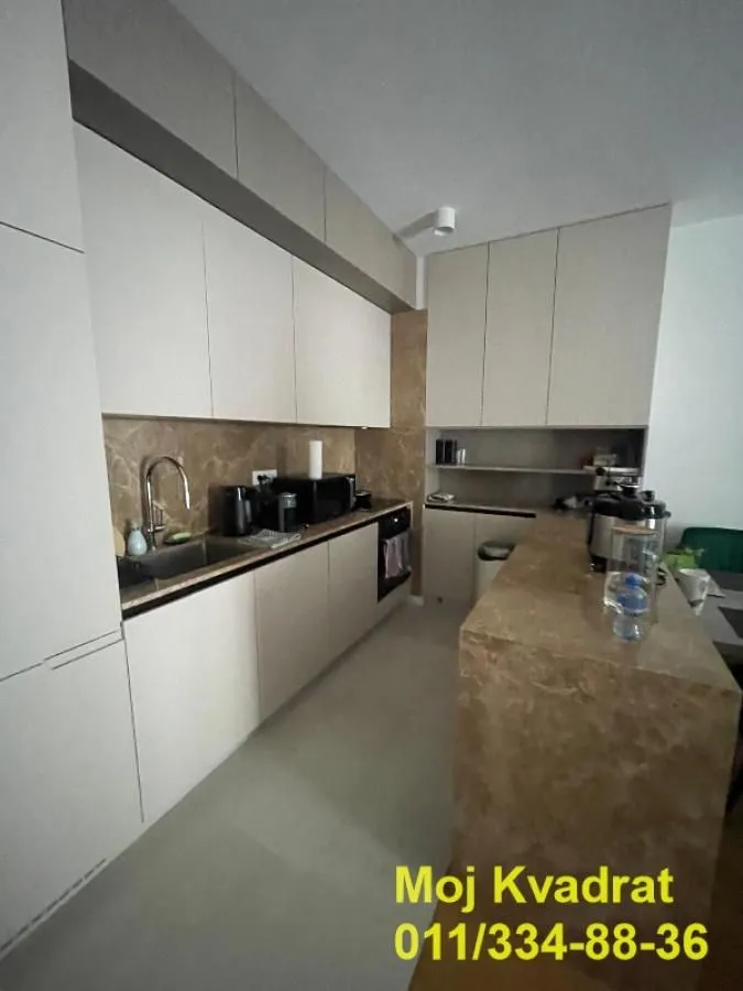 Modern kitchen with built-in cabinetry and a breakfast bar.