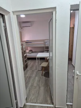View from the hallway into a bedroom with bunk beds. - image 7