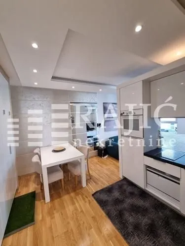 Modern kitchen with a dining area and built-in appliances.