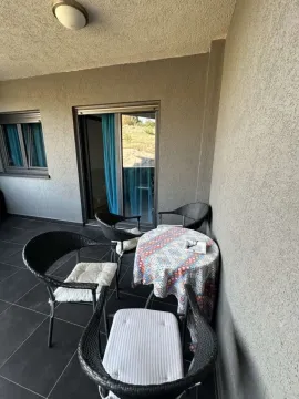 Covered terrace with seating set and table. - image 7