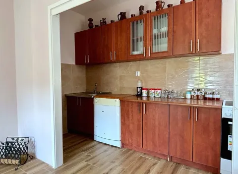 Kitchen with wooden cabinetry and ceramic tile backsplash. - image 8