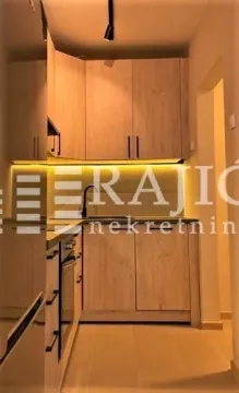 Modern kitchen with wooden cabinets and built-in lighting. - image 11