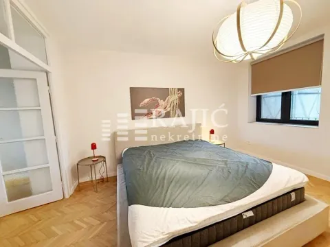 Furnished bedroom with a double bed and parquet flooring. - image 6