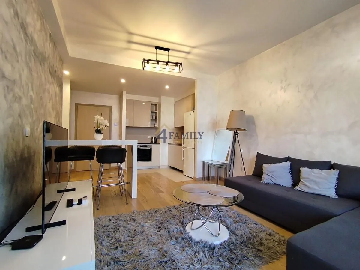 Modern and bright living room with a sofa and dining area.