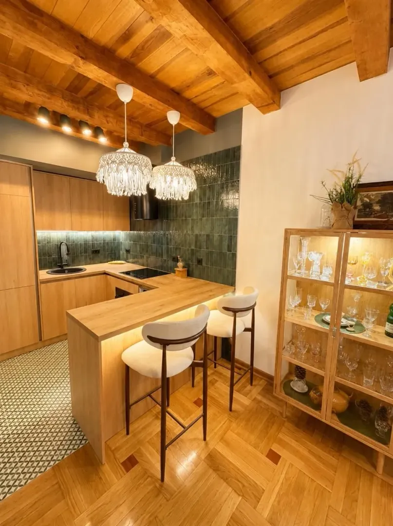 Modern kitchen with a breakfast bar and wooden ceiling.