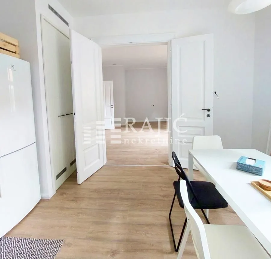Dining area with a dining table and chairs, looking towards the interior doors.