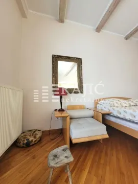 Bedroom with a bed, armchair, and wall mirror. - image 14