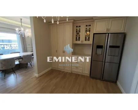 Kitchen with built-in cabinetry and a refrigerator, overlooking the dining area. - image 6
