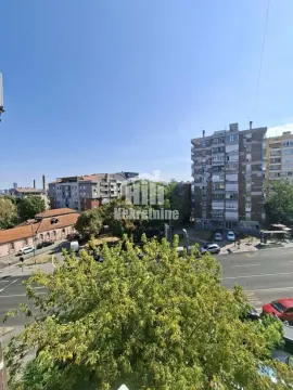 View from the window overlooking surrounding buildings and the street. - image 10