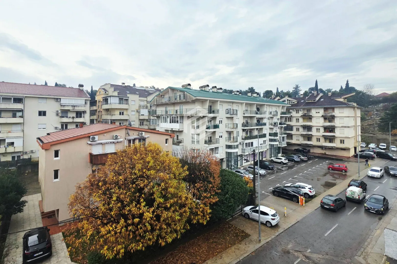 View from the window overlooking surrounding buildings and the street.