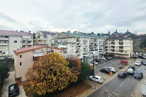View from the window overlooking surrounding buildings and the street. - image 5