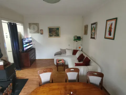 Living room with a sofa set, dining table, and TV. - image 10