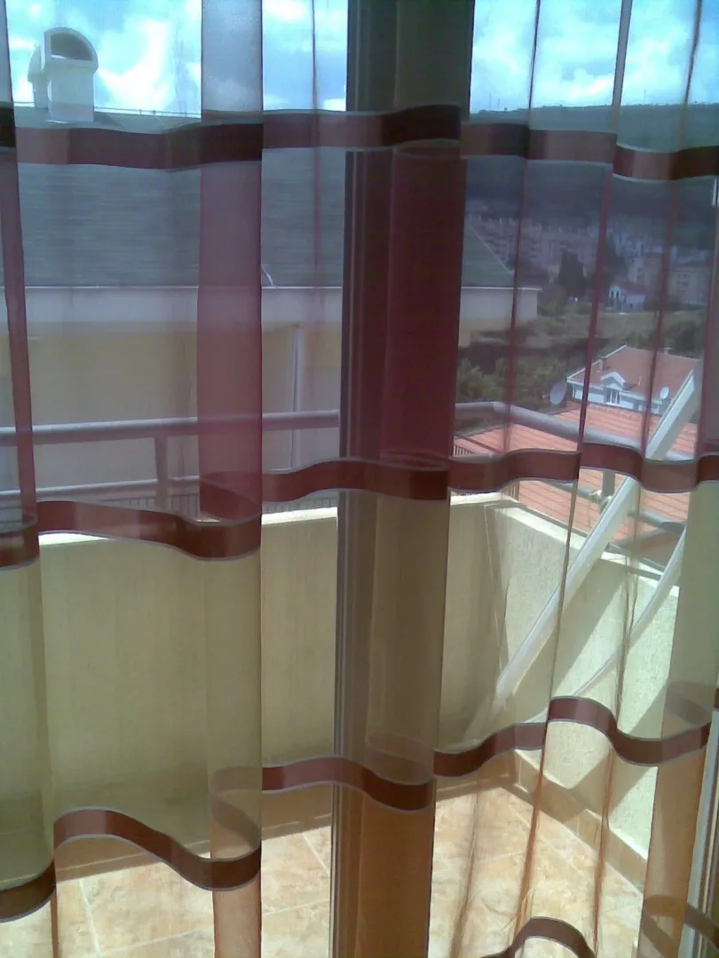 View from the terrace through window curtains.