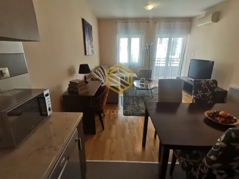 Living room with dining area and kitchen in the apartment. - image 6