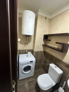 Small bathroom with a washing machine and water heater. - image 17