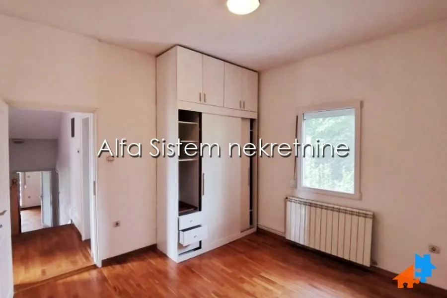 Bedroom with a built-in wardrobe and wooden flooring.