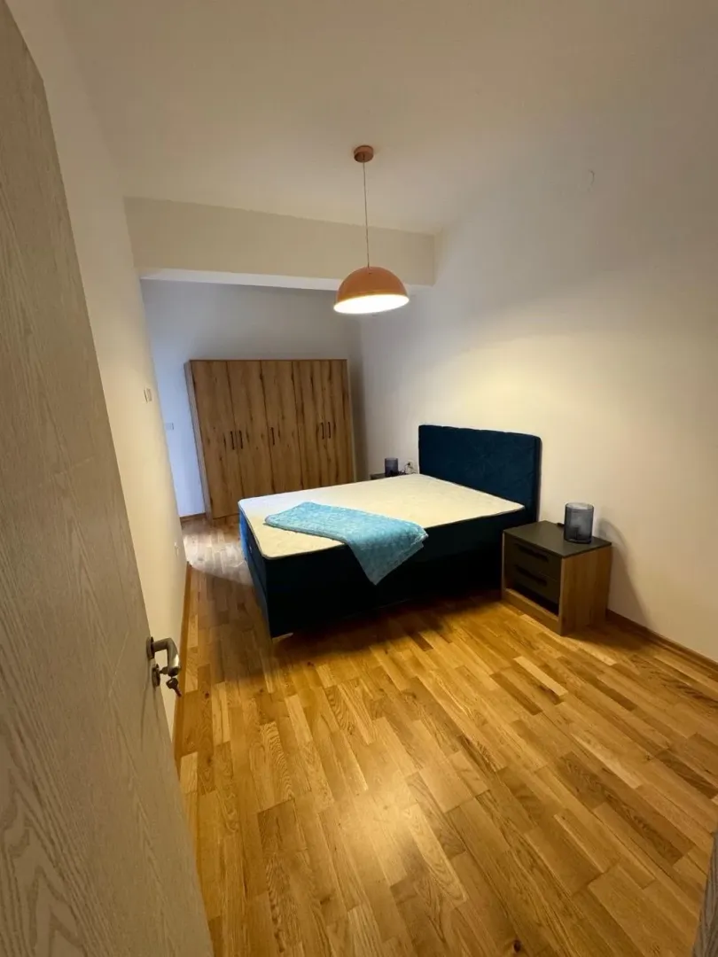 Bedroom with a double bed, wardrobe, and wooden floor.