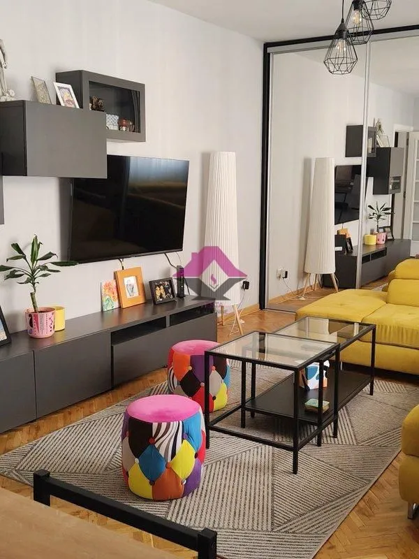 Living room with a sofa, TV, and coffee table.
