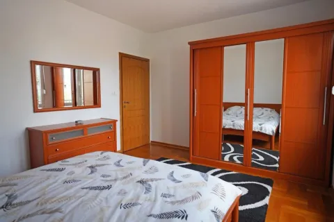 Furnished bedroom with a large wardrobe and a double bed. - image 6