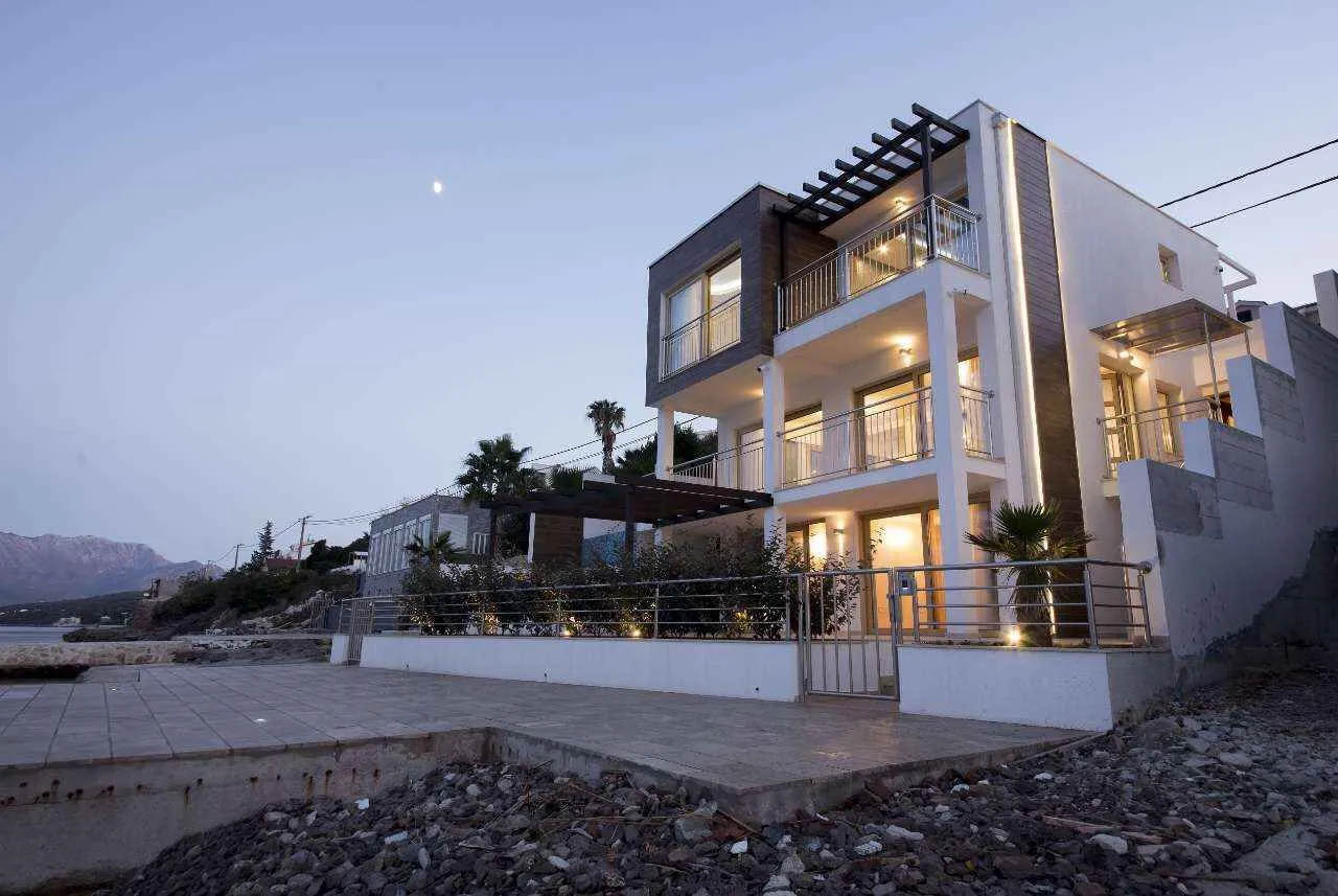 Modern multi-family house with a landscaped yard near the coast.
