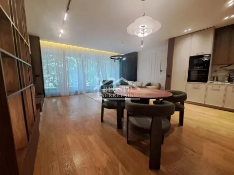 Living room with dining area and built-in kitchen in the background. - image 3