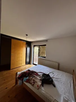 Bedroom with a double bed, wooden floor, and wardrobe. - image 10