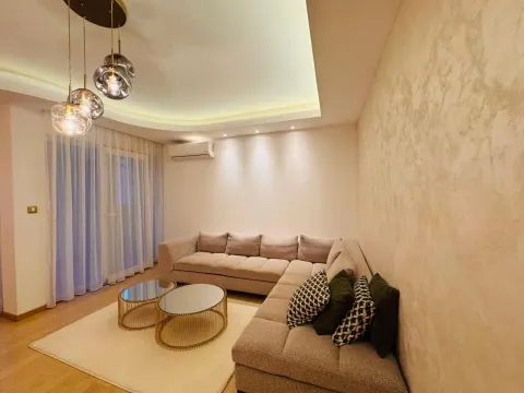 Comfortable living room with a sectional sofa and modern lighting. - image 19
