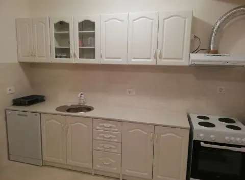Small white kitchen with cabinets, sink, stove, and dishwasher. - image 6