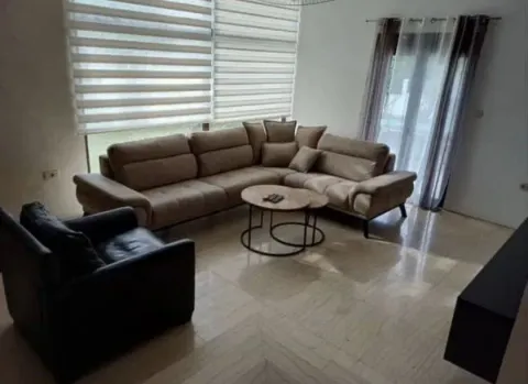 Spacious living room with a sectional sofa and large windows. - image 2