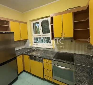 Yellow kitchen with sink, built-in oven, and refrigerator. - image 5