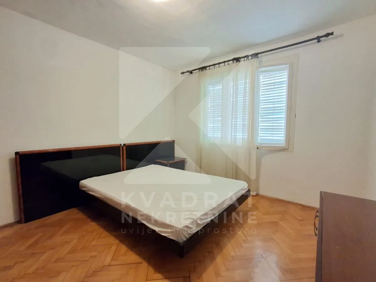 Bedroom with a double bed and a window.