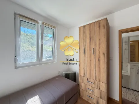 Small bedroom with a bed, wardrobe, and window. - image 12