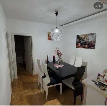 Dining area with a black table and chairs in the apartment. - image 9