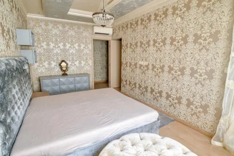 Spacious bedroom with a large bed and patterned wallpaper. - image 7