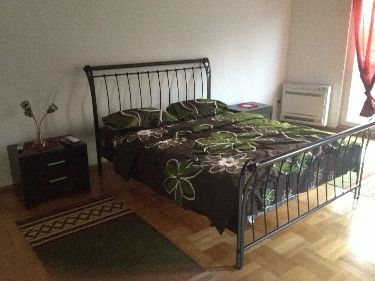 A tidy bedroom with a double bed.