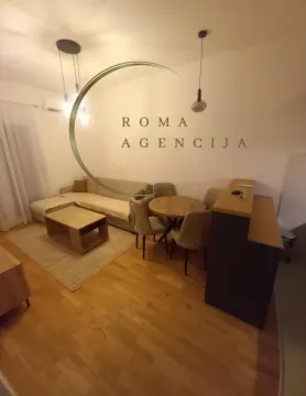 Living room with a sofa and dining table. - image 2