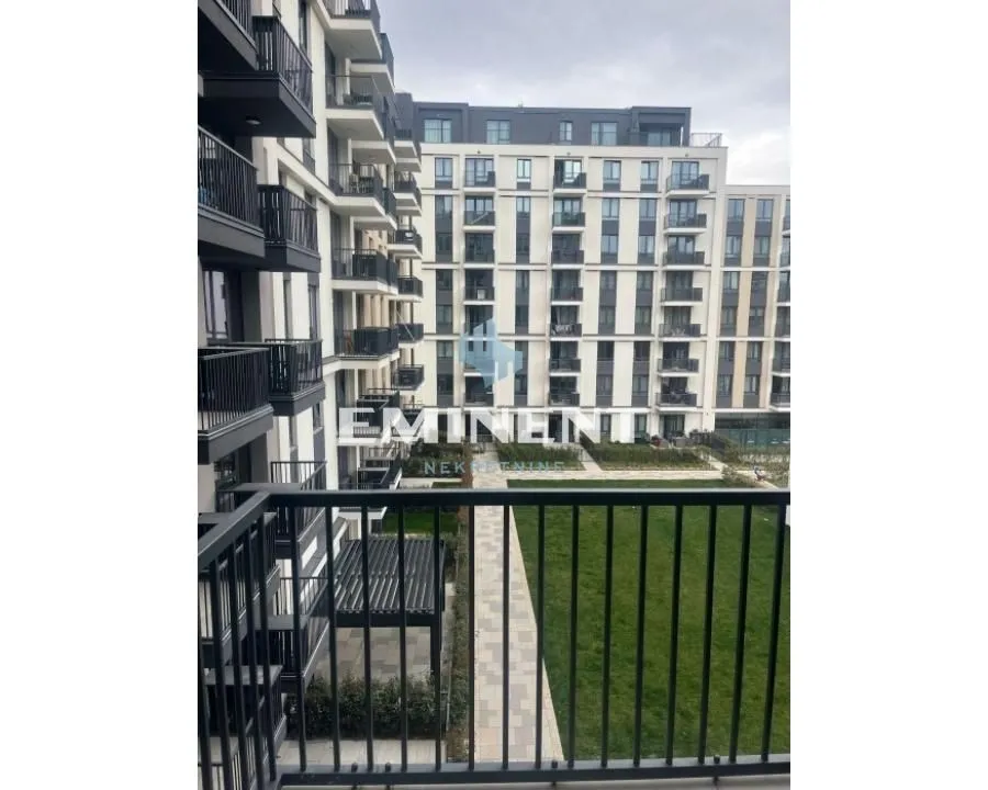 View from the balcony towards the courtyard and surrounding residential buildings.
