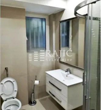 Modern bathroom with a sink, mirror, shower cabin, and toilet. - image 3