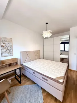 Furnished bedroom with a double bed, wardrobe, and a desk. - image 8