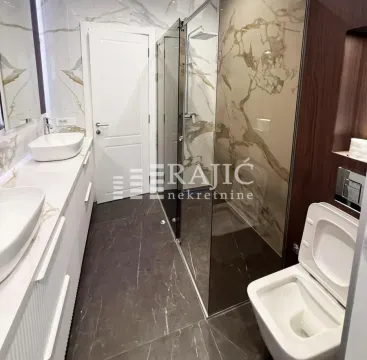 Modern bathroom with a walk-in shower and white washbasins. - image 11